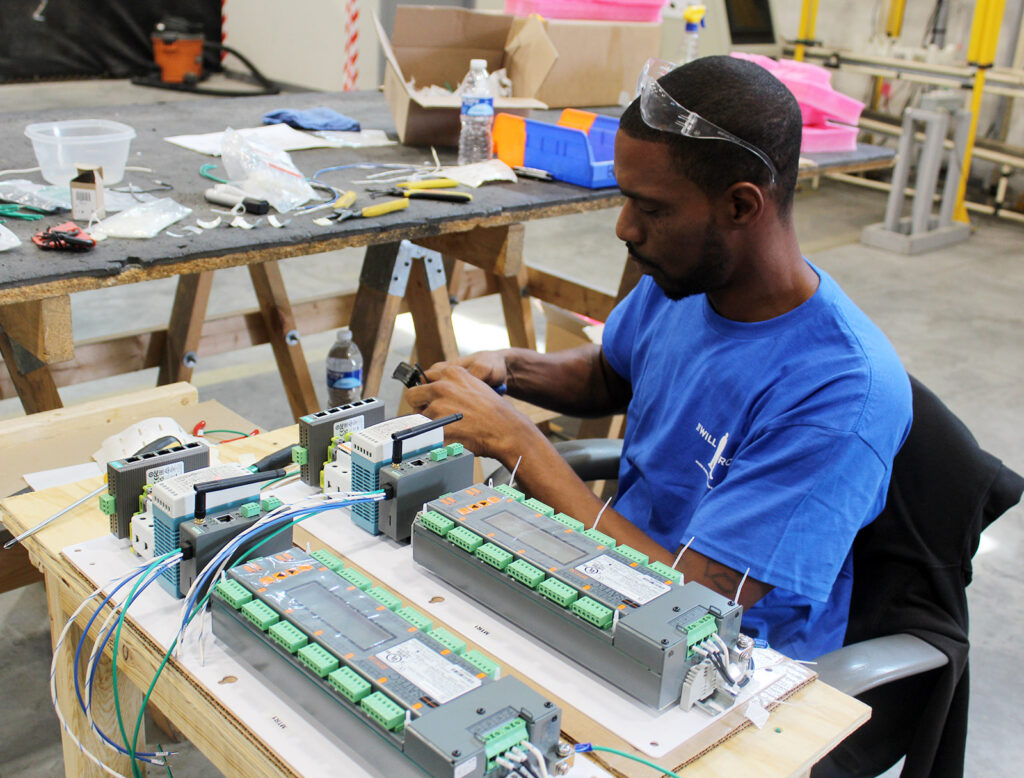 The Will Group team member assembling lighting fixtures at K-Town Business Centre